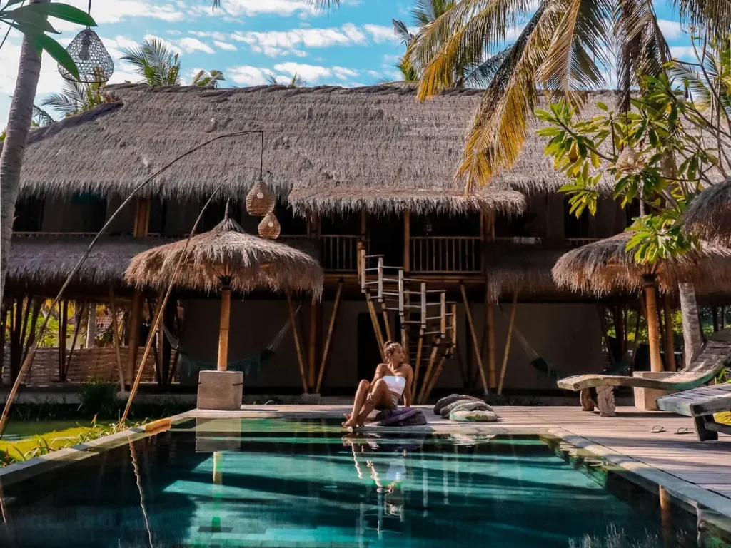 Woman soaking her feet in a vacation rental palapa